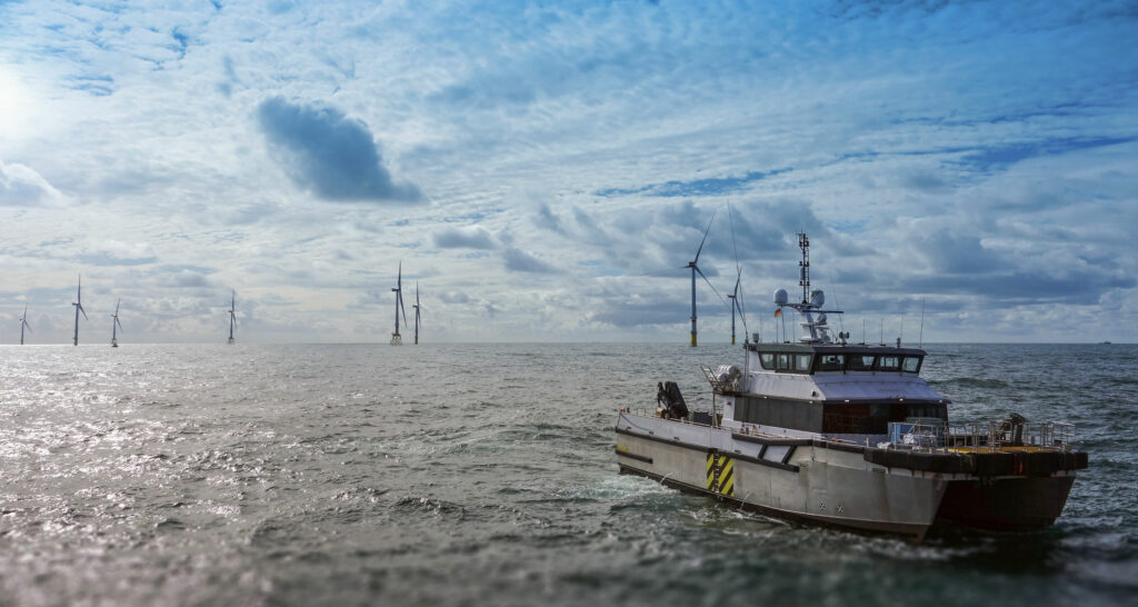 Vessel sailing away from a wind farm.
